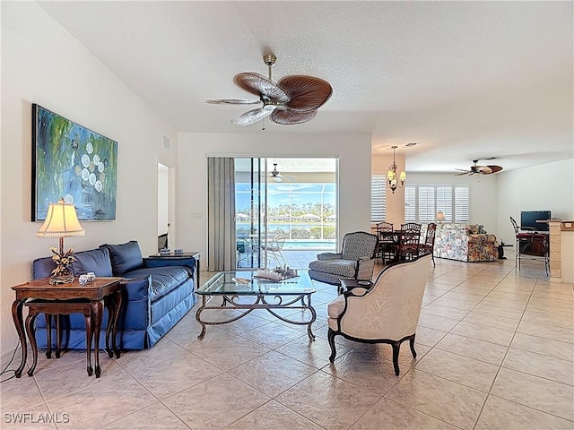 20716 Tisbury Ln, North Fort Myers, FL 33917 - living room featuring ceiling fan, a textured ceiling, visible vents, and light tile patterned flooring