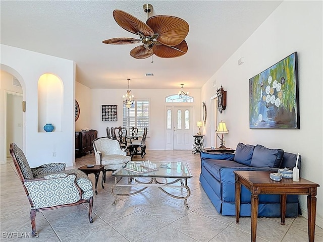 20716 Tisbury Ln, North Fort Myers, FL 33917 - living room with arched walkways, ceiling fan with notable chandelier, visible vents, and a textured ceiling