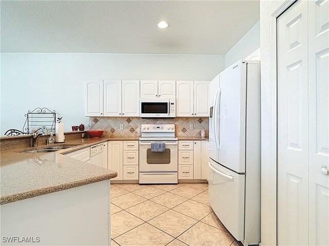 20716 Tisbury Ln, North Fort Myers, FL 33917 - kitchen featuring white appliances, a sink, light tile patterned floors, and decorative backsplash