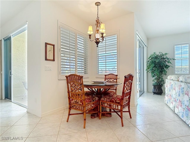 20716 Tisbury Ln, North Fort Myers, FL 33917 - dining area with light tile patterned flooring, a notable chandelier, and baseboards