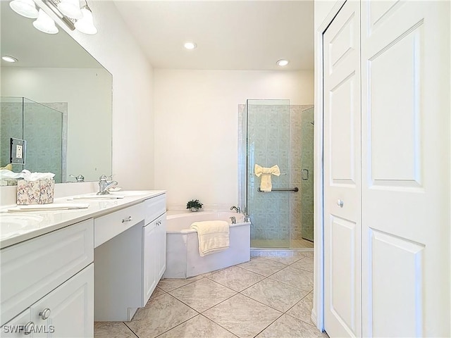 20716 Tisbury Ln, North Fort Myers, FL 33917 - bathroom with a sink, a shower stall, double vanity, tile patterned floors, and a garden tub