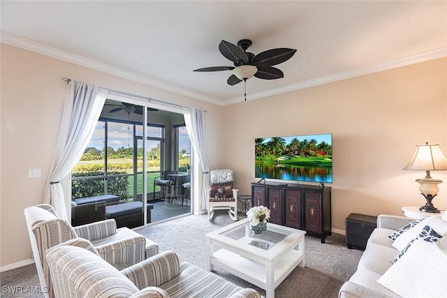 carpeted living area featuring baseboards, ornamental molding, and a ceiling fan