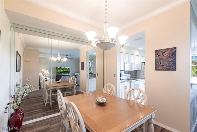 dining space with crown molding, a notable chandelier, baseboards, dark wood-type flooring, and visible vents