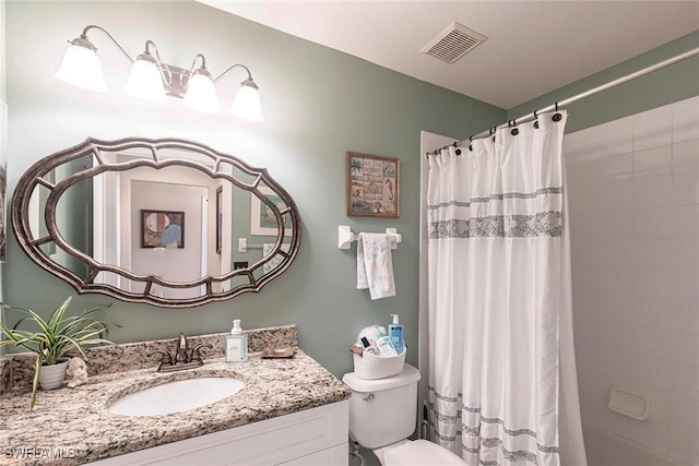 full bath featuring vanity, toilet, and visible vents