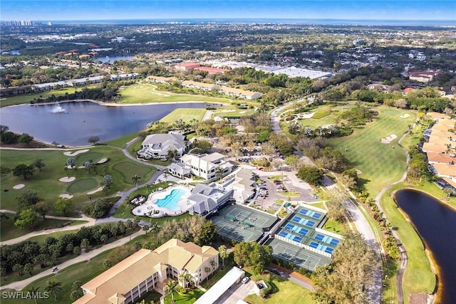 birds eye view of property with a water view and view of golf course