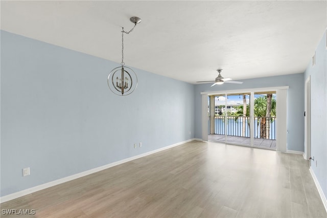 1004 Manatee Rd Unit H201, Naples, FL 34114 - spare room with light wood finished floors, a ceiling fan, a chandelier, and a water view