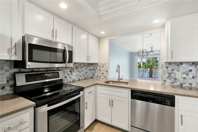 1004 Manatee Rd Unit H201, Naples, FL 34114 - kitchen with stainless steel appliances, white cabinets, ornamental molding, and recessed lighting