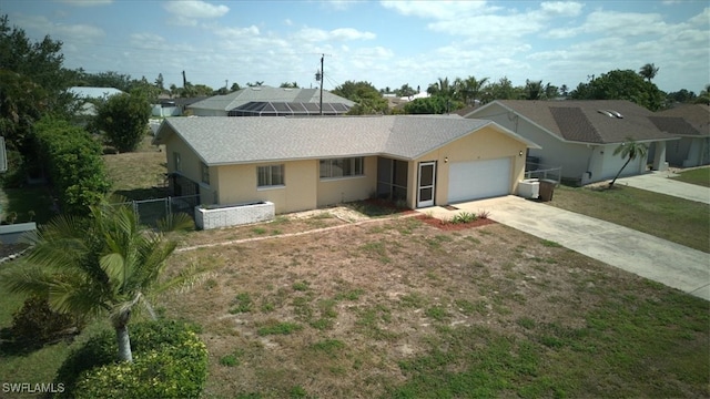 ranch-style house with an attached garage, driveway, roof with shingles, stucco siding, and fence