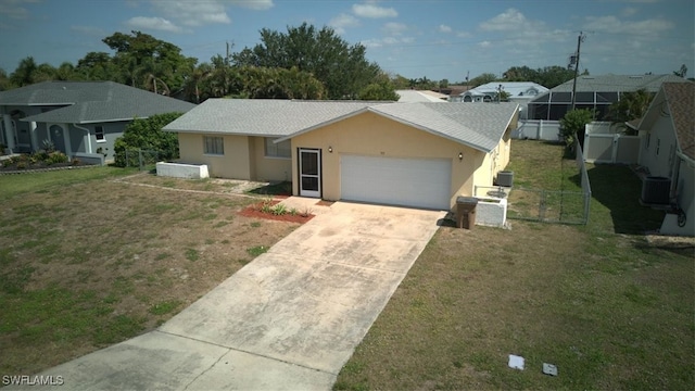 ranch-style home featuring fence, concrete driveway, a front lawn, and a garage