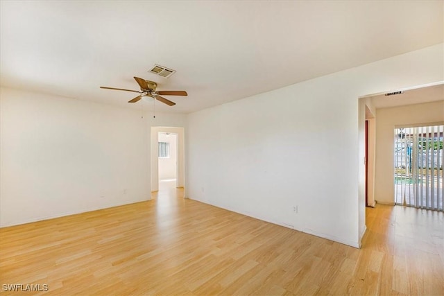 spare room featuring visible vents, a ceiling fan, and light wood-style floors