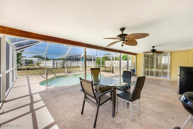 sunroom / solarium with ceiling fan and a swimming pool