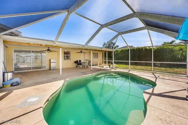outdoor pool featuring a patio, ceiling fan, and a lanai