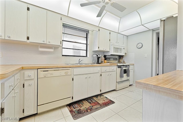 845 Collier Ct Unit 503, Marco Island, FL 34145 - kitchen with white appliances, a sink, light tile patterned floors, light countertops, and backsplash