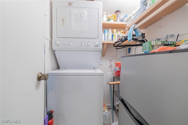 845 Collier Ct Unit 503, Marco Island, FL 34145 - laundry room featuring stacked washer and clothes dryer