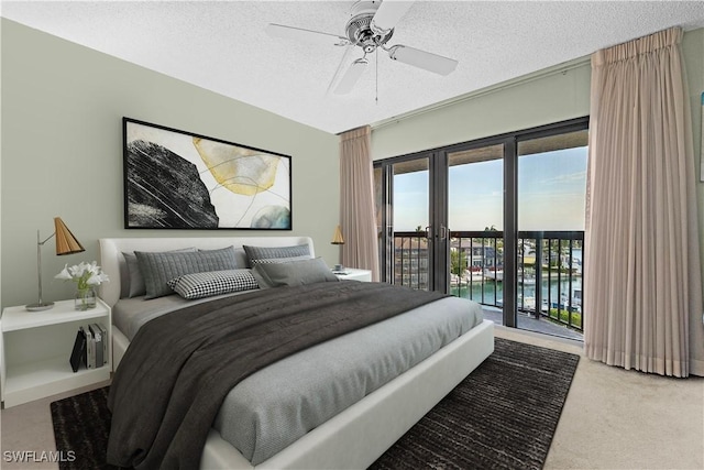 845 Collier Ct Unit 503, Marco Island, FL 34145 - bedroom with access to exterior, carpet floors, a textured ceiling, and a ceiling fan