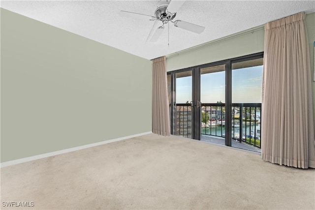 845 Collier Ct Unit 503, Marco Island, FL 34145 - spare room with carpet, a ceiling fan, baseboards, and a textured ceiling