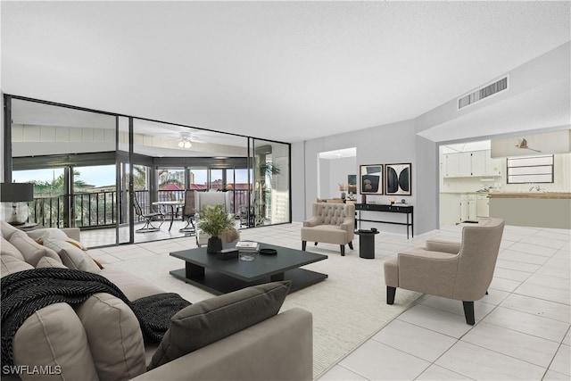 845 Collier Ct Unit 503, Marco Island, FL 34145 - living area featuring plenty of natural light, light tile patterned flooring, and ceiling fan