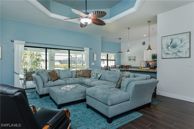 2714 SW 28th Ave, Cape Coral, FL 33914 - living room featuring a raised ceiling, baseboards, visible vents, ceiling fan, and dark wood-style flooring