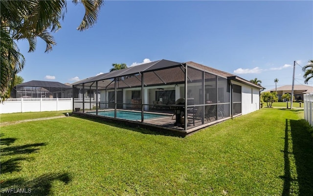 2714 SW 28th Ave, Cape Coral, FL 33914 - rear view of house with a lawn, a fenced in pool, fence, and a lanai