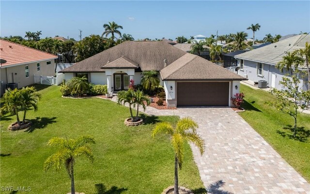 2714 SW 28th Ave, Cape Coral, FL 33914 - ranch-style home featuring fence, driveway, a front yard, and a garage