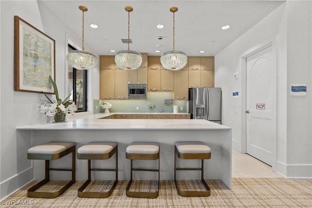 20333 Fair Oak Ln, Estero, FL 33928 - kitchen featuring light countertops, tasteful backsplash, visible vents, a peninsula, and appliances with stainless steel finishes
