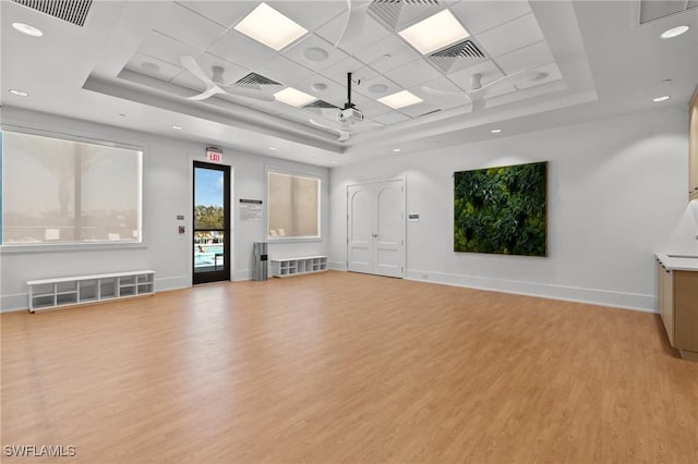 20333 Fair Oak Ln, Estero, FL 33928 - unfurnished living room with baseboards, a tray ceiling, and light wood finished floors