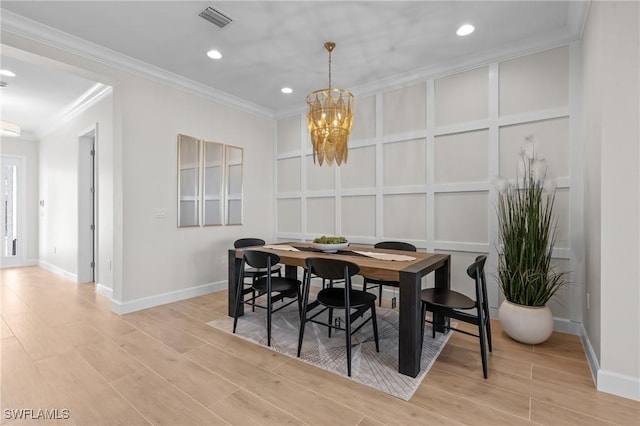 20333 Fair Oak Ln, Estero, FL 33928 - dining area with a decorative wall, light wood-style flooring, visible vents, a chandelier, and ornamental molding