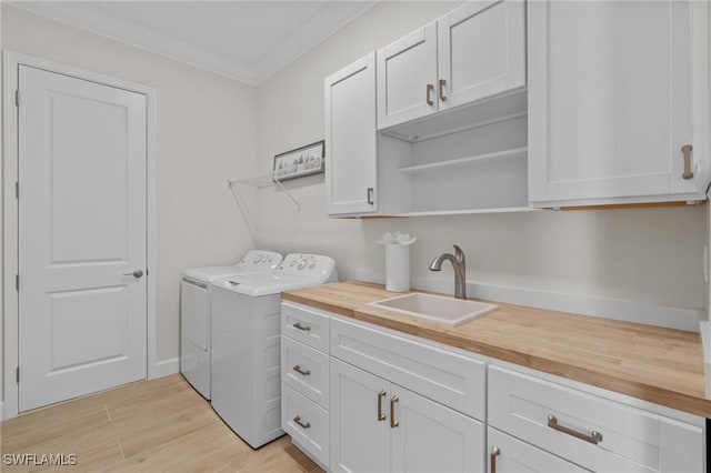 20333 Fair Oak Ln, Estero, FL 33928 - washroom with crown molding, independent washer and dryer, a sink, light wood finished floors, and cabinet space