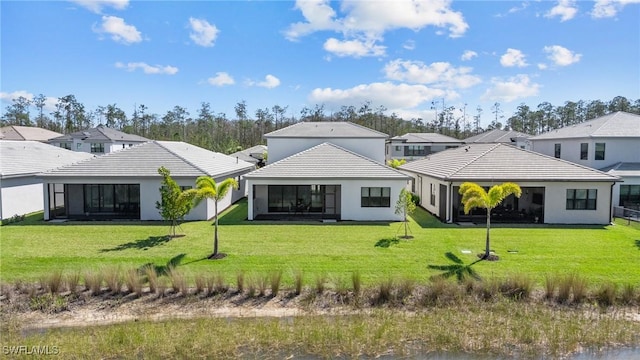 20333 Fair Oak Ln, Estero, FL 33928 - back of property featuring a lawn, a tiled roof, and stucco siding