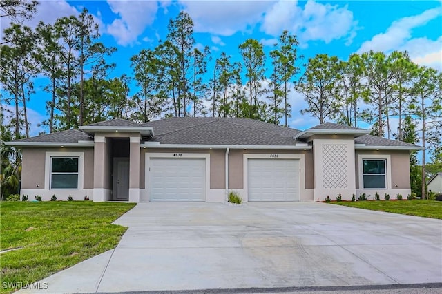 4636-4638 29th St SW, Lehigh Acres, FL 33973 - prairie-style home featuring concrete driveway, a front lawn, a garage, and stucco siding