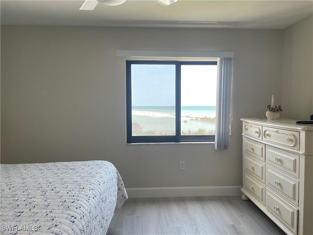 6672 Estero Blvd Unit A606, Fort Myers Beach, FL 33931 - bedroom with baseboards, light wood-type flooring, and a water view