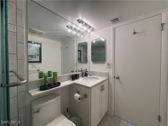 6672 Estero Blvd Unit A606, Fort Myers Beach, FL 33931 - bathroom featuring toilet, vanity, and tile patterned floors