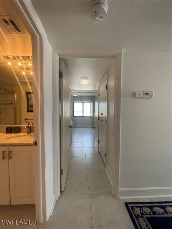 6672 Estero Blvd Unit A606, Fort Myers Beach, FL 33931 - corridor with a sink, light tile patterned floors, and baseboards