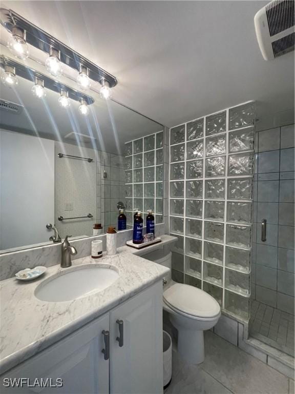 6672 Estero Blvd Unit A606, Fort Myers Beach, FL 33931 - full bath with a stall shower, tile walls, vanity, tile patterned floors, and toilet