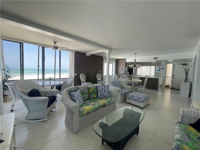 6672 Estero Blvd Unit A606, Fort Myers Beach, FL 33931 - living area featuring view of water and beach, light tile patterned flooring, decorative columns, ceiling fan, and a chandelier