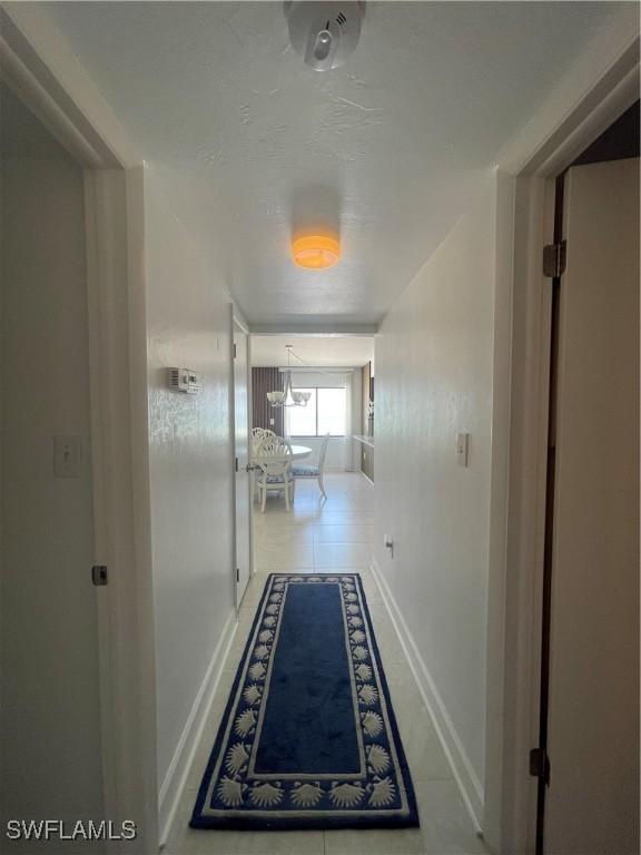 6672 Estero Blvd Unit A606, Fort Myers Beach, FL 33931 - corridor featuring baseboards and a chandelier