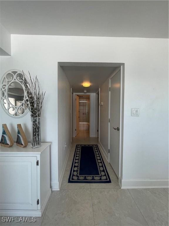 6672 Estero Blvd Unit A606, Fort Myers Beach, FL 33931 - hallway with light tile patterned floors and baseboards