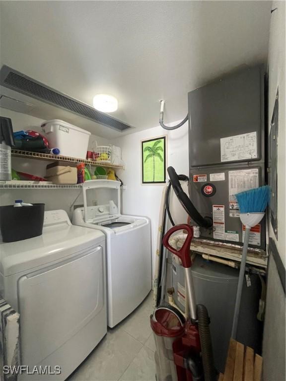 6672 Estero Blvd Unit A606, Fort Myers Beach, FL 33931 - clothes washing area with washer and dryer and light tile patterned flooring
