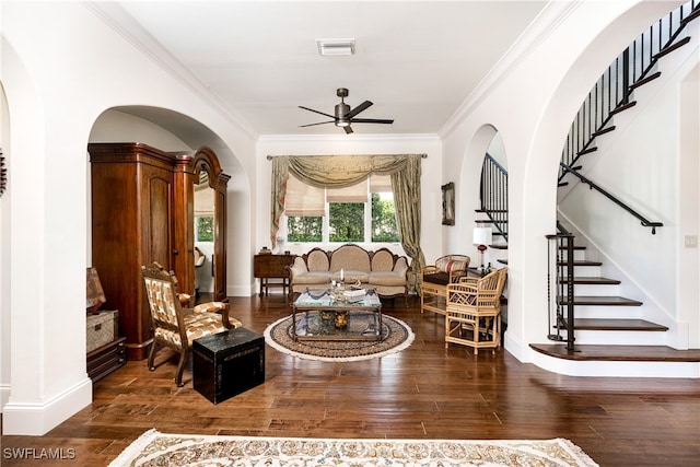 living area featuring stairs, wood finished floors, visible vents, ceiling fan, and ornamental molding