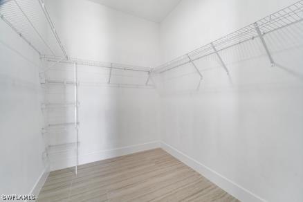 2803 17th St W, Lehigh Acres, FL 33971 - walk in closet with wood finished floors