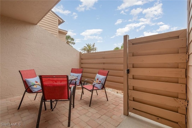 view of patio / terrace with outdoor dining space and fence