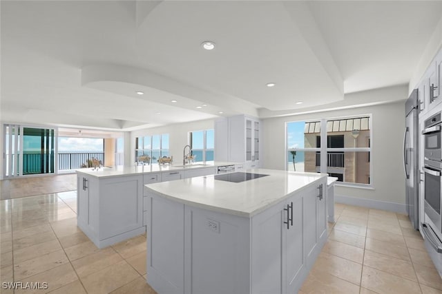 3127 W Gulf Dr Unit 106, Sanibel, FL 33957 - kitchen with a peninsula, plenty of natural light, recessed lighting, a kitchen island, and a sink