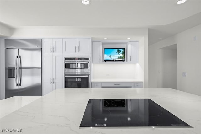 3127 W Gulf Dr Unit 106, Sanibel, FL 33957 - kitchen featuring white cabinetry, light stone countertops, stainless steel appliances, and recessed lighting