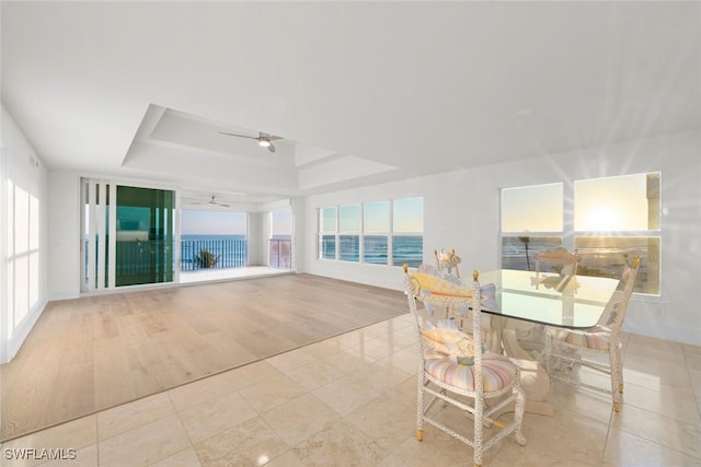3127 W Gulf Dr Unit 106, Sanibel, FL 33957 - tiled dining space featuring a ceiling fan and a raised ceiling