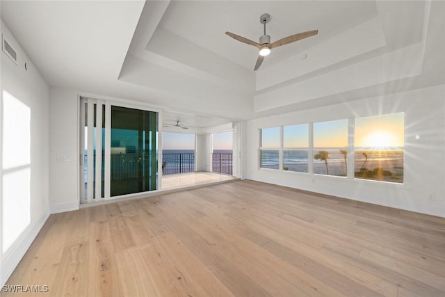 3127 W Gulf Dr Unit 106, Sanibel, FL 33957 - empty room with visible vents, a ceiling fan, wood finished floors, and a raised ceiling
