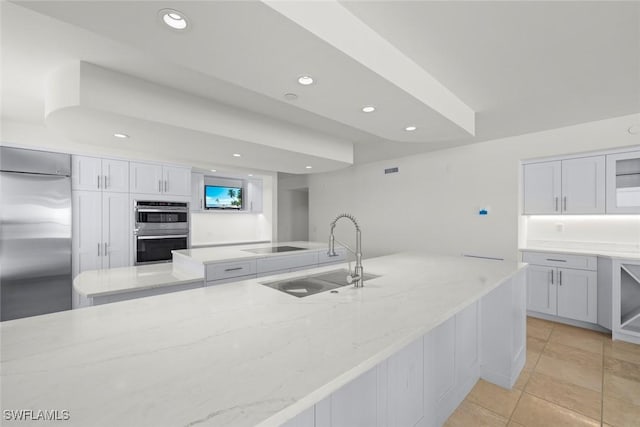 3127 W Gulf Dr Unit 106, Sanibel, FL 33957 - kitchen featuring light stone counters, a sink, stainless steel appliances, white cabinets, and recessed lighting