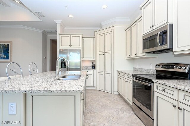 6561 Dominica Dr Unit 8-201, Naples, FL 34113 - kitchen with crown molding, a sink, visible vents, stainless steel appliances, and a kitchen island with sink