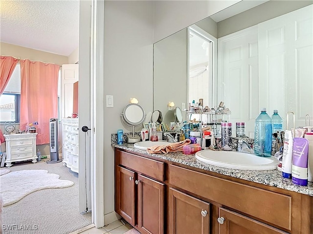 5356 Brin Way, Ave Maria, FL 34142 - bathroom featuring double vanity, a sink, and a textured ceiling