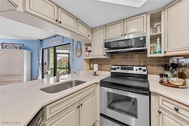 9623 Eaton Gardens Ln Unit 105, Fort Myers, FL 33919 - kitchen featuring light countertops, a sink, tasteful backsplash, and appliances with stainless steel finishes