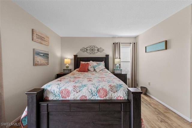 9623 Eaton Gardens Ln Unit 105, Fort Myers, FL 33919 - bedroom with baseboards and light wood finished floors